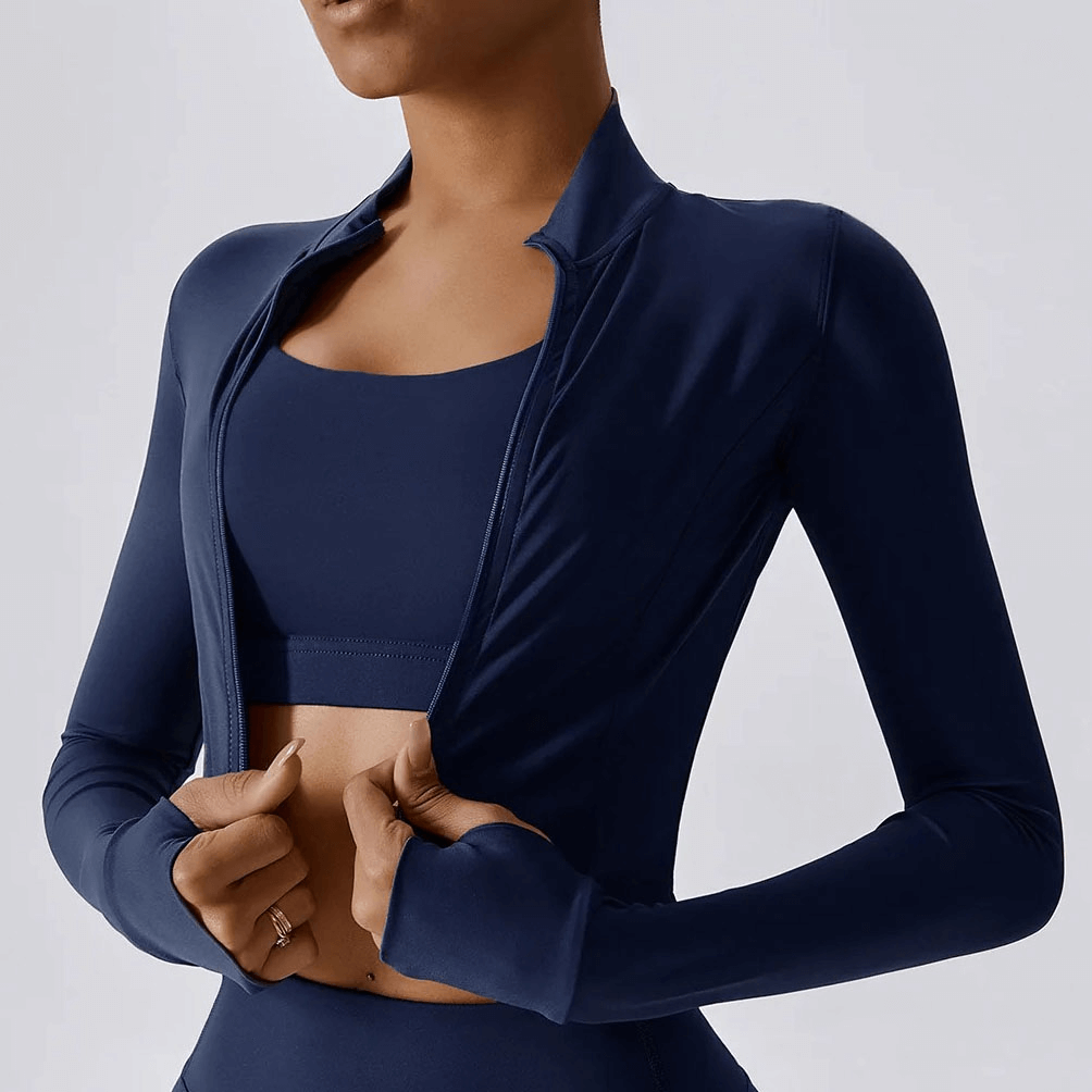 Woman wearing navy quick-drying long-sleeved yoga shirt with zipper, ideal for workouts and high-intensity activities.